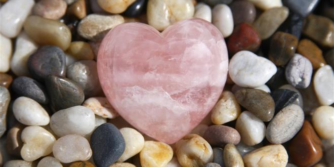 a pebble rock garden with a rose quartz heart