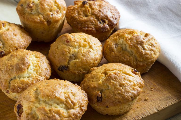 A cluster of seven muffins on a serving board.