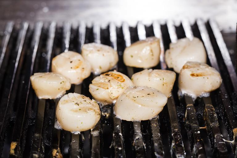 scallops cooking on a grill